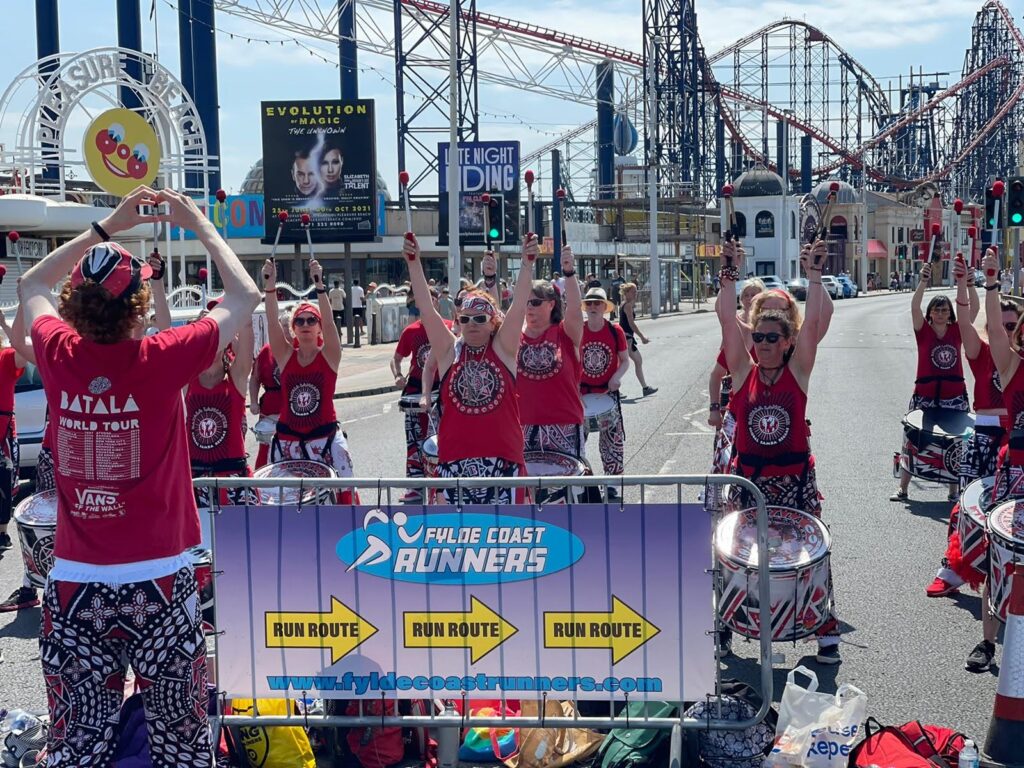 Drummers in front of Blackpool rollercoasters