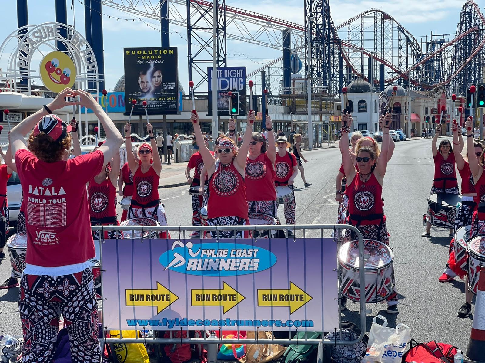 Drummers in front of Blackpool rollercoasters